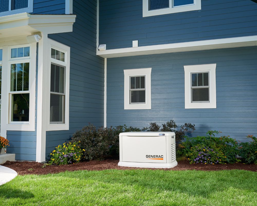 Home Backup Generac Generator in front of blue home.
