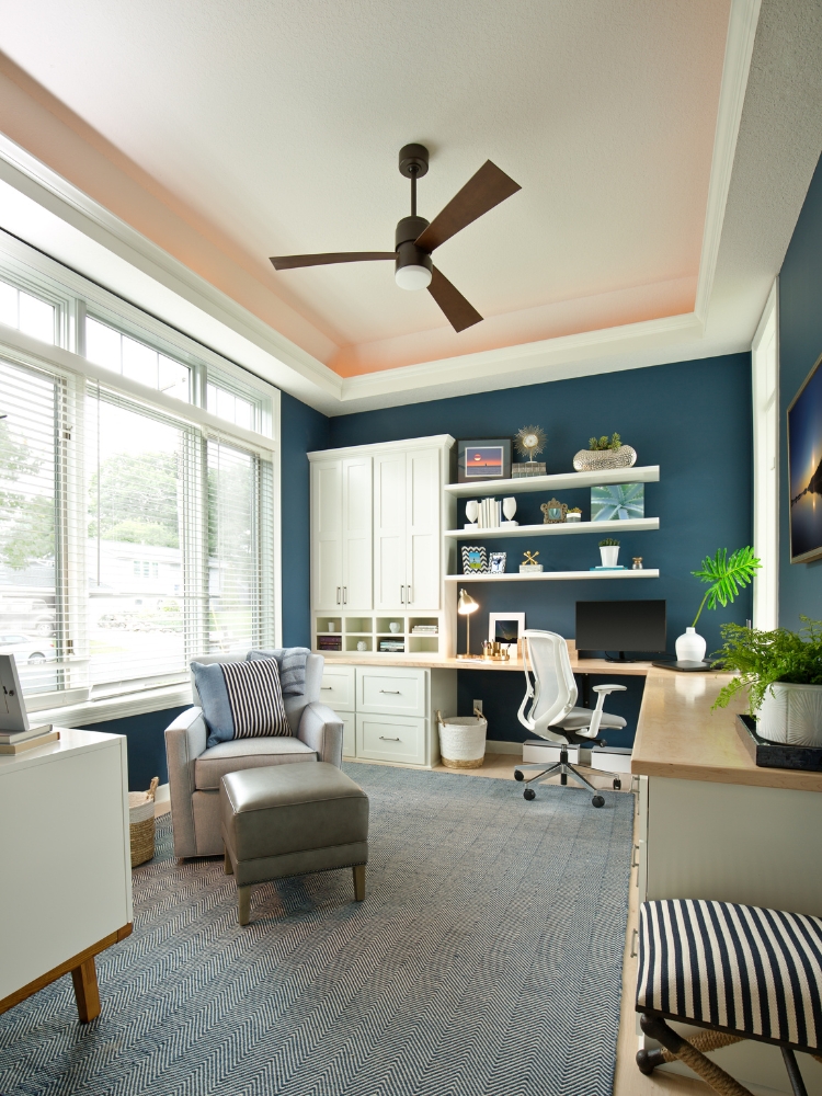 Tankless water heater and electrical conduits mounted on a brick exterior wall with exposed wiring.