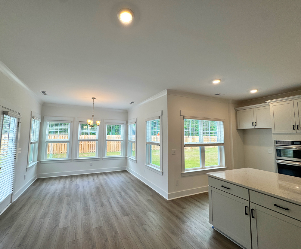 electrician installing light on new construction using cardboard to protect paint
